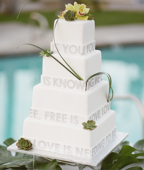 Elegant wedding cake with romantic quotes and floral decor