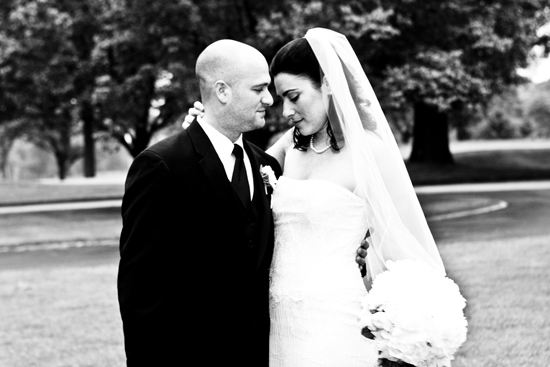 A newlywed couple share an intimate moment at a wedding