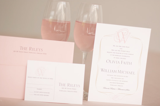 Elegant wedding invitation with pink champagne glasses and stationery