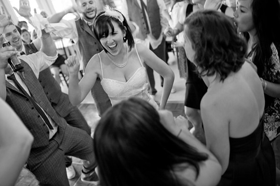 Bride dances joyfully with guests at a wedding reception party