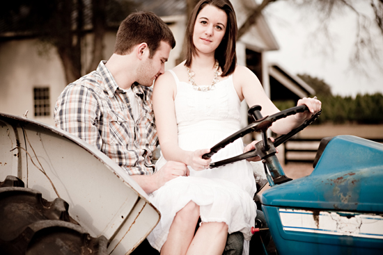 Romantic couple in love on a blue tractor, rural setting