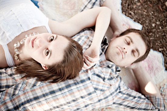 Couple relaxing on a blanket, gazing up at the sky together