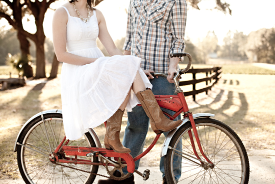 Couple with a red bike in a charming countryside setting