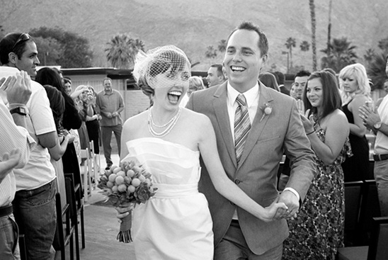 Newlyweds laughing and holding hands on their wedding day, happy and smiling
