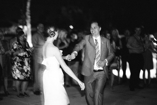 Couple dancing joyfully at a wedding reception, celebrating