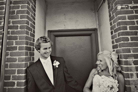Happy couple laughing on their wedding day in black and white photo
