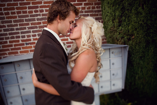 Wedding couple sharing an intimate kiss, captured in a warm embrace