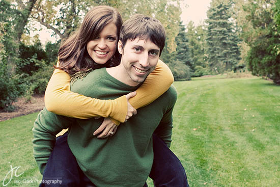 Happy couple enjoying a piggyback ride outside in the park