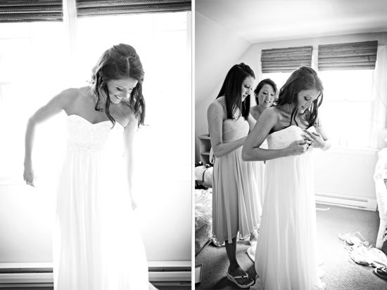 Bride getting ready in wedding dress with bridesmaids