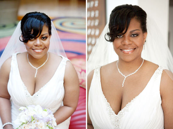Smiling bride in a white wedding dress with veil and bouquet