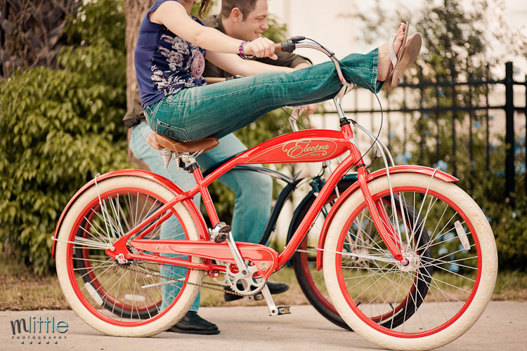 Couple riding red bike outdoors