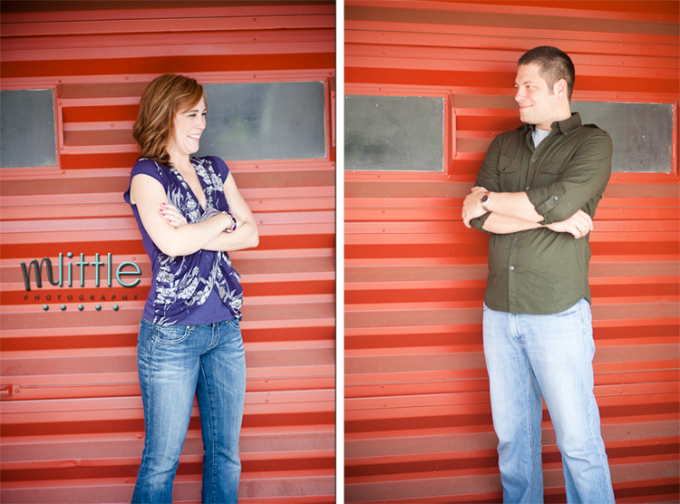 Couple posing against red corrugated wall