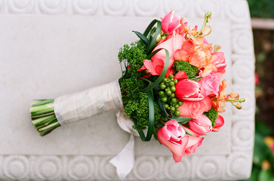 Stunning coral and pink wedding bouquet with greenery