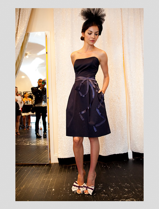 Woman in black strapless dress with bow heels