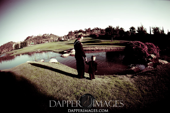Father and son by pond at golf course