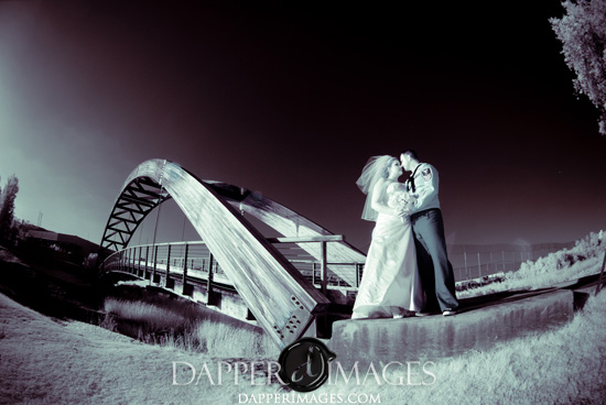 Couple kissing on bridge, wedding photo