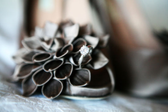 Engagement ring on elegant shoe with flower detail