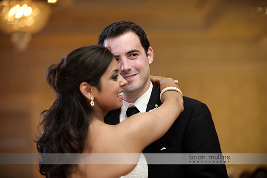 Happy newlywed couple embracing during their wedding dance together