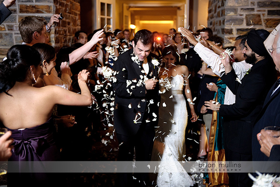 Newlyweds showered with petals as they exit wedding reception