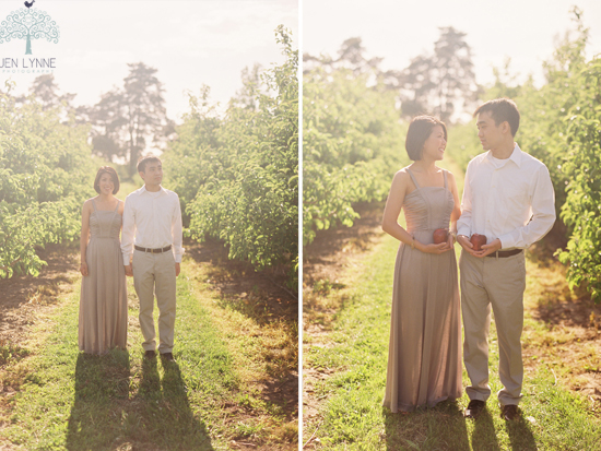 Couple holding apples in orchard engagement photo
