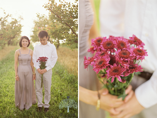 Couple posing with flowers in orchard