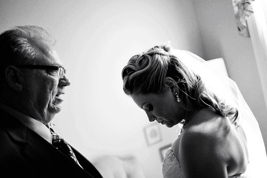 Father lovingly watches his daughter in her wedding dress