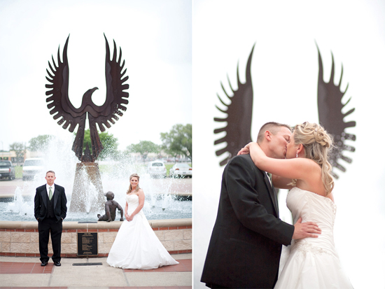 Couple kissing in front of metal eagle statue