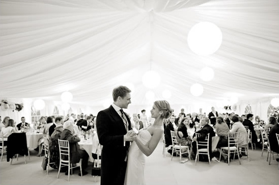 Bride and groom first dance at tented wedding venue