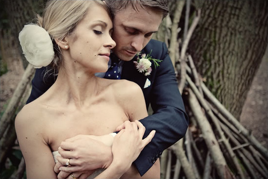 Bride and groom embracing at outdoor wedding ceremony