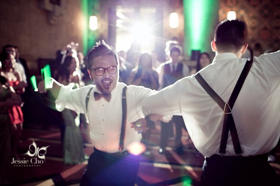 Happy groomsmen dancing at wedding reception
