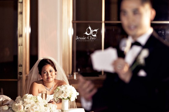 Bride smiles during wedding reception toast