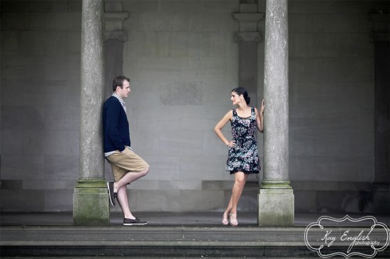 Romantic couple posing near pillars, engagement photo