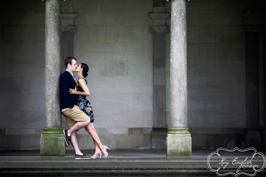 Couple kissing under colonnade