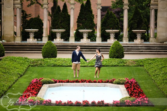 Couple holding hands in garden fountain