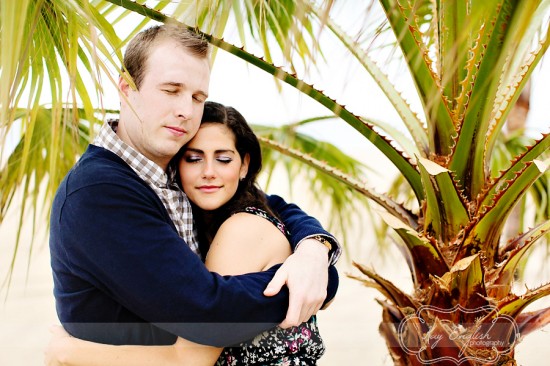 Couple embracing under palm trees