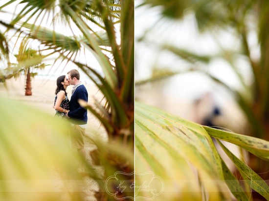 Romantic couple kissing, hidden behind palm fronds