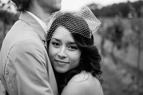 Bride with veil, embracing groom