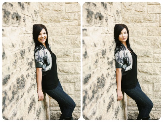 Woman leaning against a stone wall smiling and looking at the camera