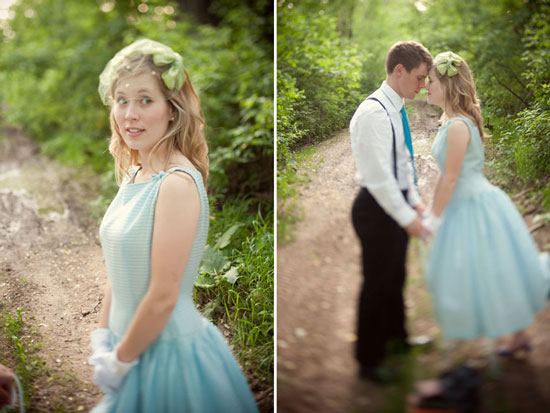 Couple in vintage attire share a tender moment on a forest path