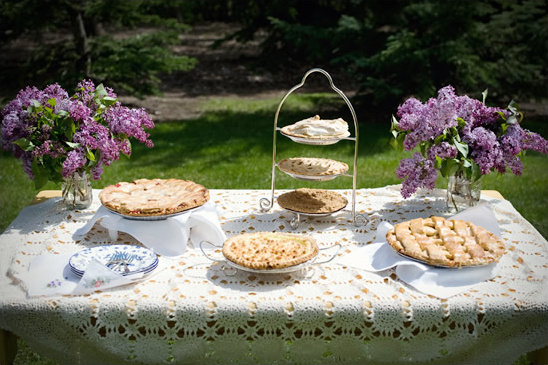Delicious pies and purple flowers arranged for a picnic outdoors