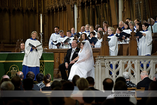 Couple at wedding ceremony, with choir, minister and congregation