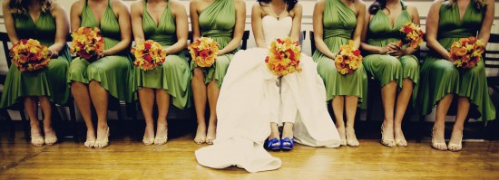 Bridesmaids in green dresses with bouquets at a wedding ceremony