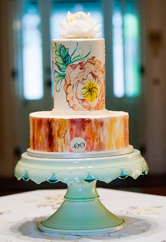 Two tier watercolor painted wedding cake on mint stand