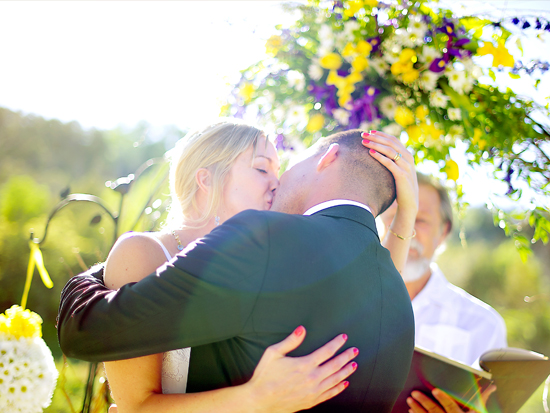 Couple kissing at outdoor wedding