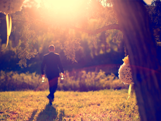 Man in suit walks outdoors, sunny day
