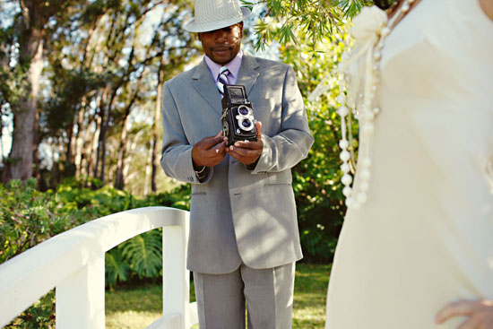 Photographer with vintage camera taking wedding photos