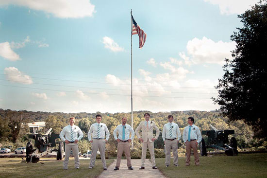 grooms men lined up in front of civil war weapons