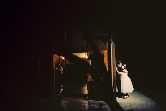 Bride and groom embrace at a night wedding venue
