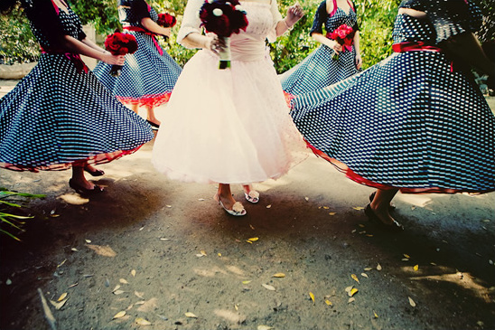 Bride and bridesmaids in polka dot dresses dancing