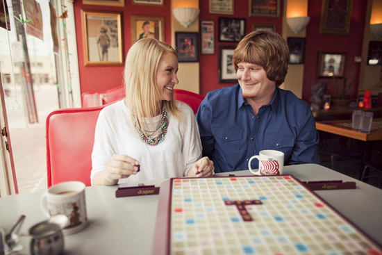 Couple smiling while playing scrabble in a cozy diner